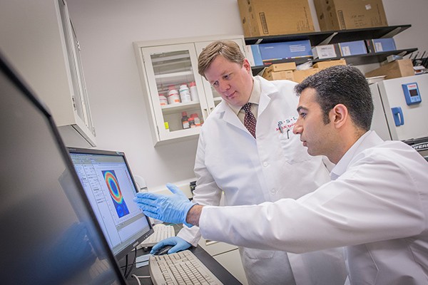 Kamran Makarian works with a Villanova engineering professor in the lab.