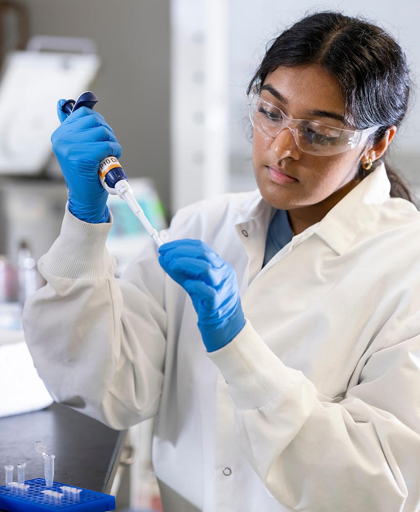 A student works with a pipet in a Chemistry lab