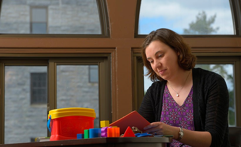  Janette Herbers in front of large window in office reading