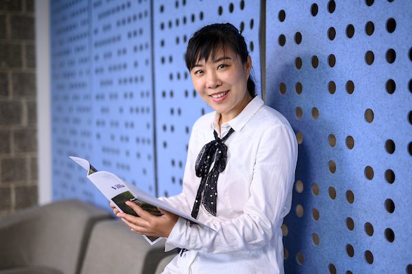 Image of a woman reading a magazine