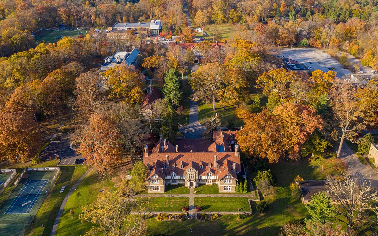 Aerial view of Cabrini’s campus in the fall, with colorful autumn foliage surrounding the buildings.